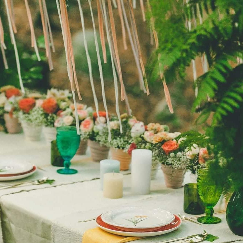 Intimate celebration table decorated with flowers and greenery